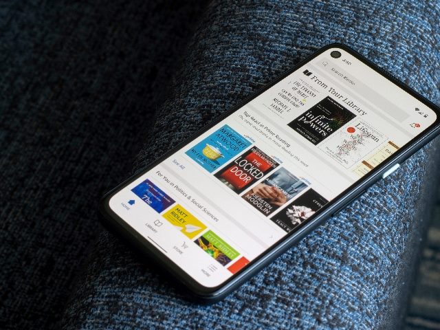 A smartphone screen shows Kindle recommendations for Top Books in piece about personalized strategy in marketing. 