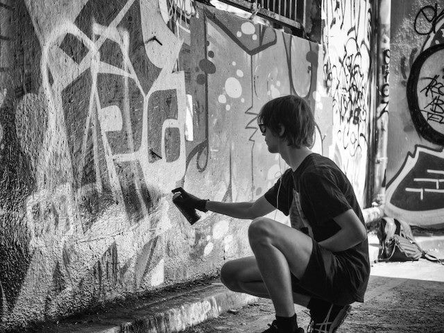 grafffiti artist tagging wall