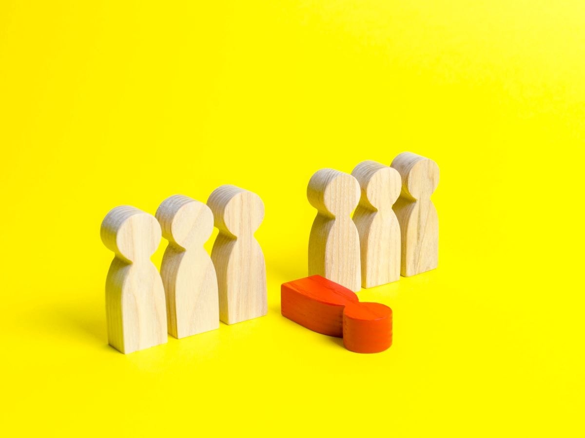 Wooden peg figures stand in two groups on a bright yellow background, with one red figure lying horizontally between them, symbolizing a weak link or service breakdown within a customer experience system.