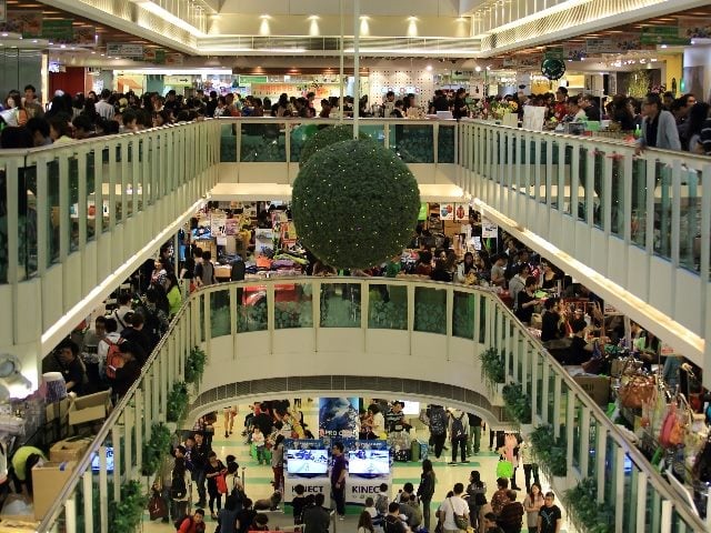People walk through a crowded shopping mall in in Hong Kong. Does your company have a customer-centric approach'?