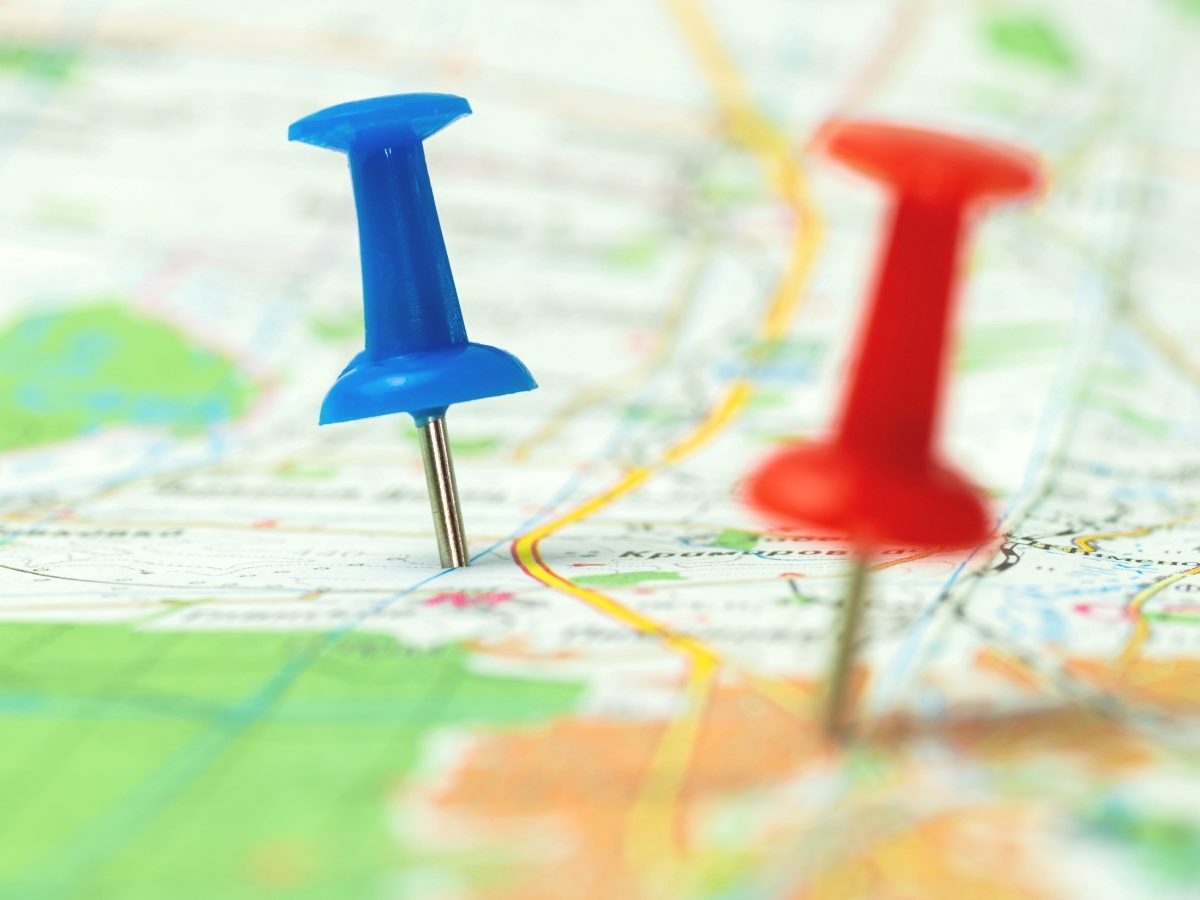 A red and a blue pin on a roadmap.