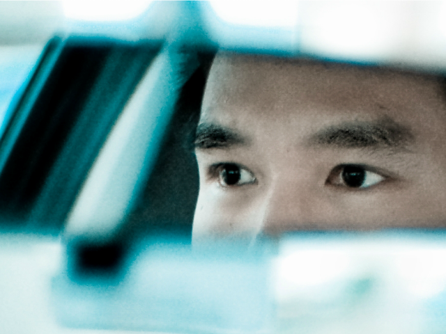 man looking ahead in the car