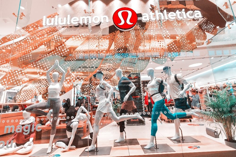 A closeup of the Lululemon Athletica store in Emirates Mall displaying sportswear products in a window display in piece about brand experience building.