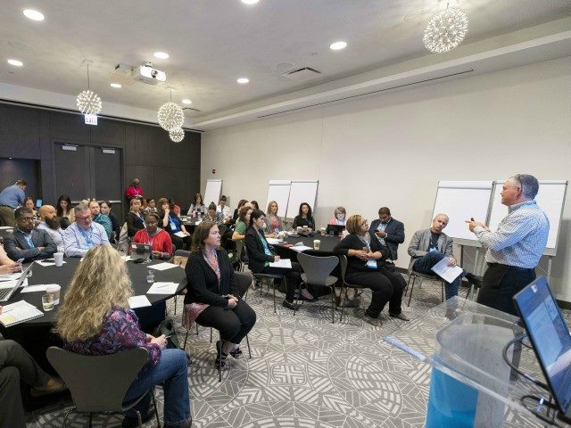 Attendees at the Digital Workplace Experience 2019 conference listen to a speaker in a breakout session.