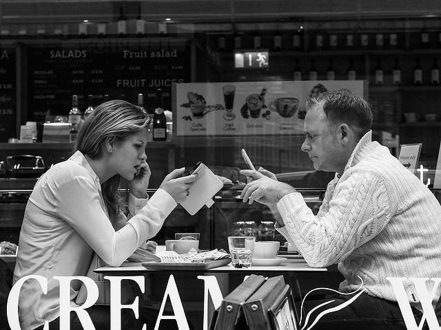 ignoring each other, on their phones