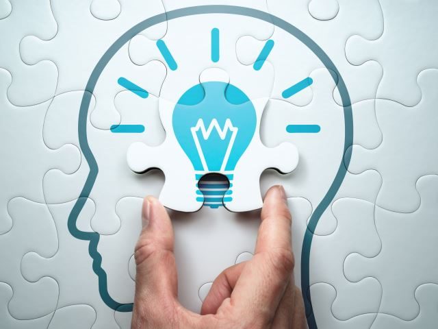 Connecting the last jigsaw puzzle piece> The picture of a human head with a light bulb inside