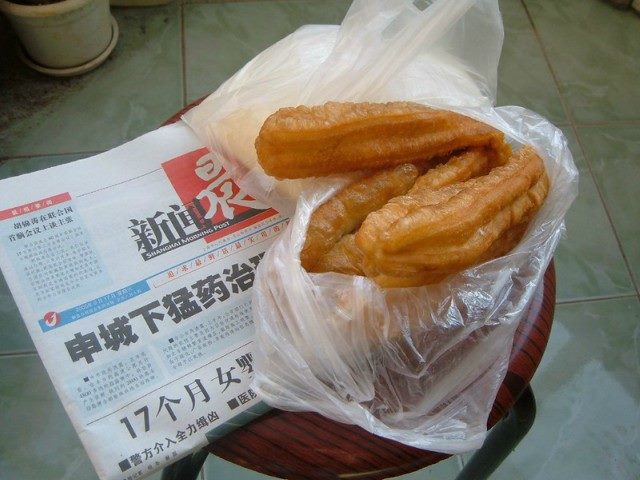 a breakfast treat in a plastic bag on top of a newspaper