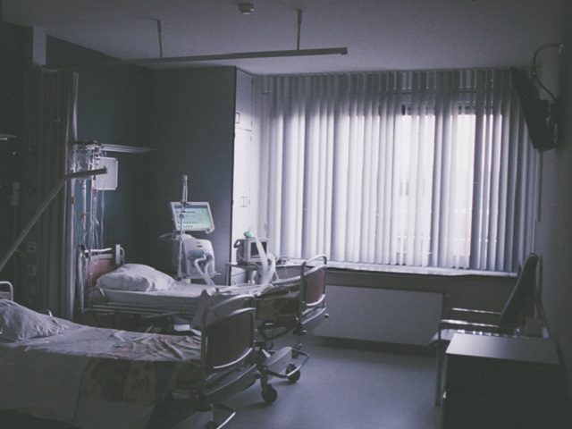 A black-and-white image of a hospital room. 
