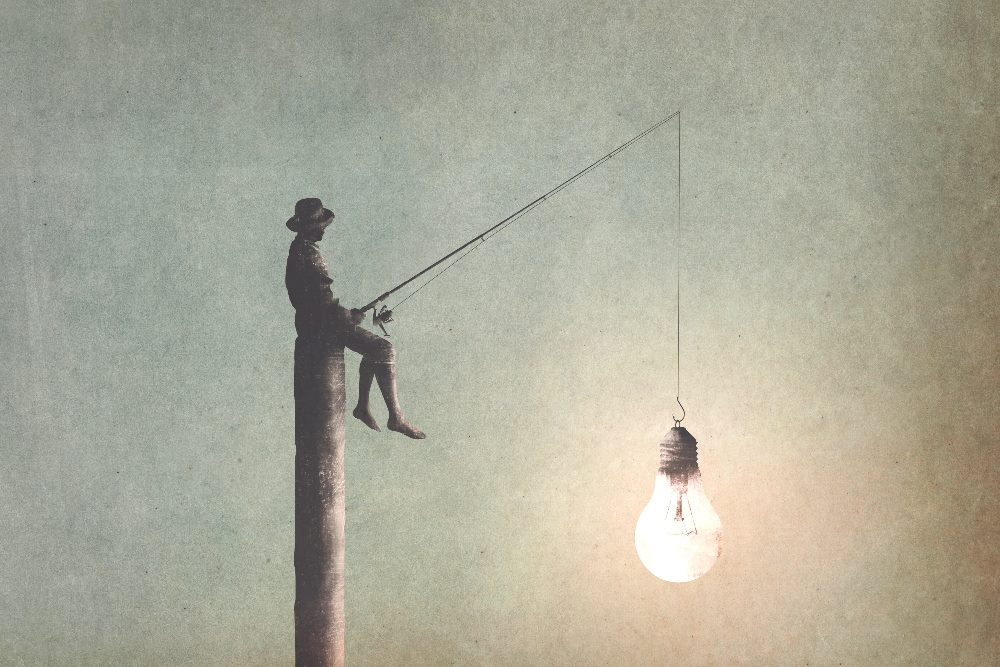 An illustration of a man fishing for new ideas with a fishing pole and line that has a light bulb on hte hook in neutral tones in piece about creative thinking.