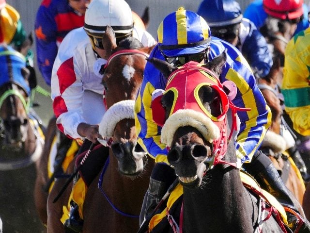 Jockey's in colorful outfits of red, white and blue, ride masked horses in a race in story about generative AI history.