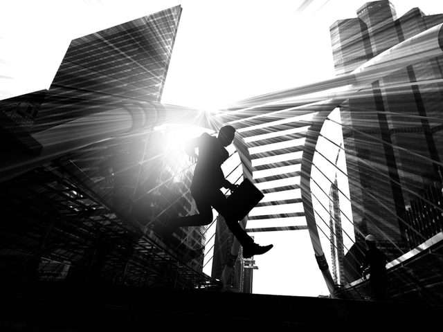 Businessman jumping over obstacles- black and white concept