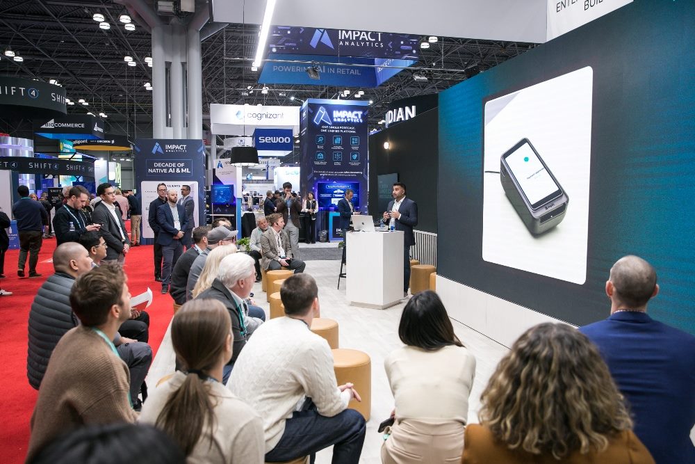 The National Retail Federation's (NRF) “Big Show” was held in New York City in 2024; people gather around a display at the show.