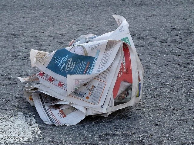 newspaper blowing in the wind on the ground
