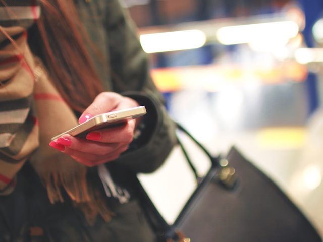 business person with cell phone in hand