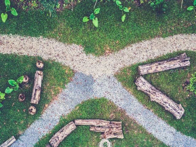 A converging set of wooded trails with big logs carved out for benches - technology converging concept