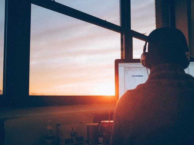 man on laptop with headphones