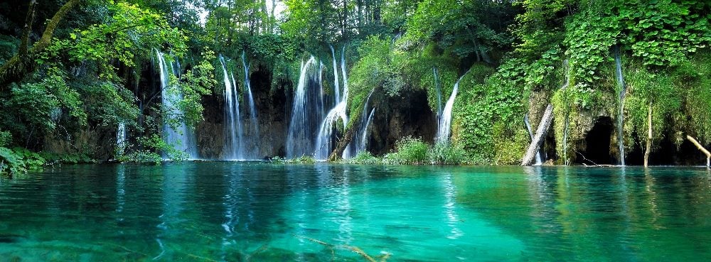 Multiple waterfalls with clear water in Plitvice National Park, Croatia, in piece about unified brand experience and chief marketing officers.