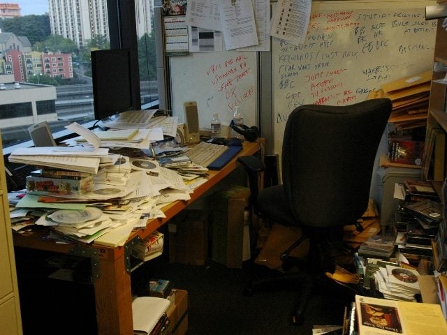 An empty office with mountains of paperwork.