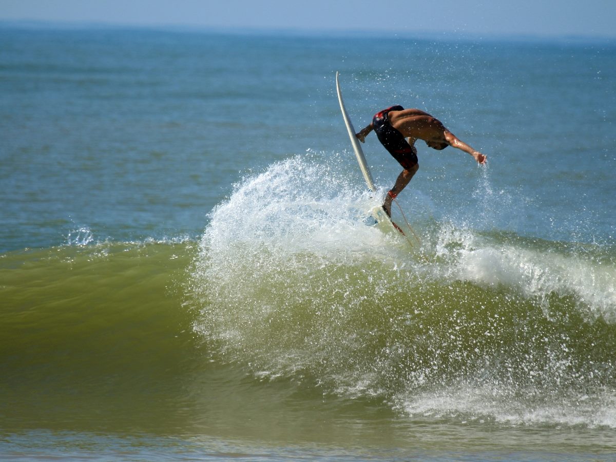 Surfer encountering a rough wave.