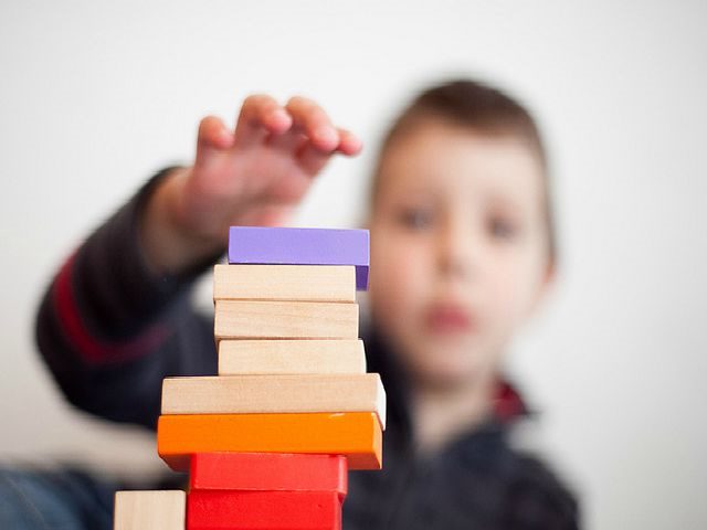 young boy building blocks