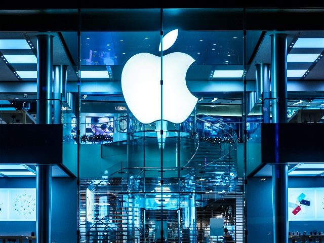 The Apple Logo on Apple Store facade in Hongkong at night in piece about Apple's embracing of AI. 