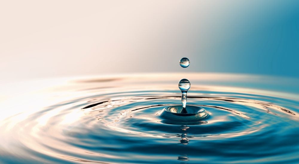 Clear Water drop with circular waves in piece about the impact of agile customer journey orchestration.