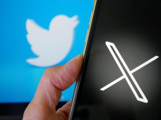 Photo shows the new logo X for twitter on blue background with white bird. 