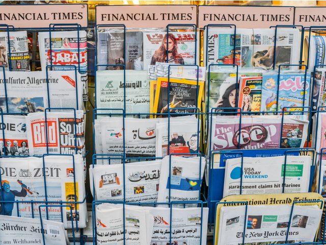 Close up of British and international magazines and newspapers for sale at a London newsstand in London.