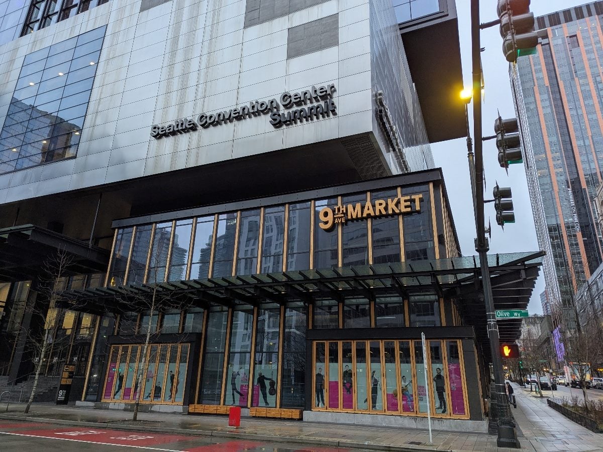 SEATTLE -- March 18, 2026: Exterior view of the Seattle Convention Center Summit building at the corner of 9th Avenue and Olive Way in downtown Seattle, with surrounding city streets and high-rise buildings visible.