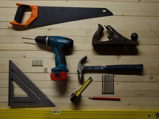 collection of handheld tools arranged on a table