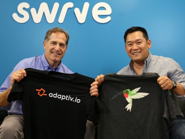 Swrve CEO Christopher Dean (left) holding an adaptiv.io T-Shirt and David Lee holding a Swrve T-Shirt