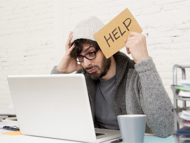 Marketing worker holding help sign, overwhelmed by marketing platform