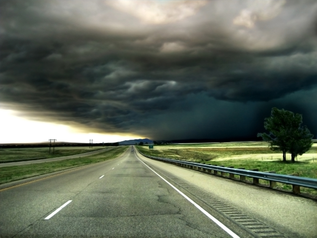A highway scene with Stormy weather ahead - trouble ahead concept