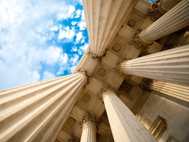 Columns at the U.S. Supreme Court, looking up from the ground. 