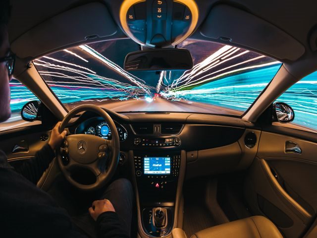 Customer driving a car loaded with tech - Customers driving digital transformation concept. 