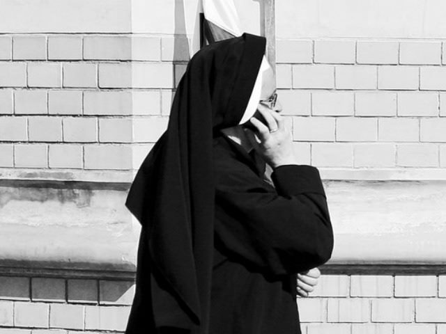 modern nun talking on cell phone