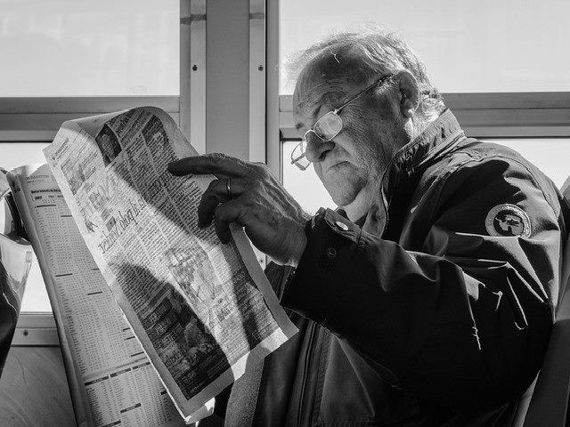 Man reading a newspaper.