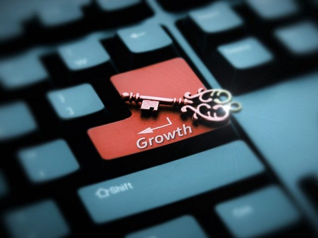 Key on keyboard with a Return Key labeled "growth."