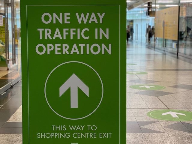 sign directing in store traffic, shopping during covid