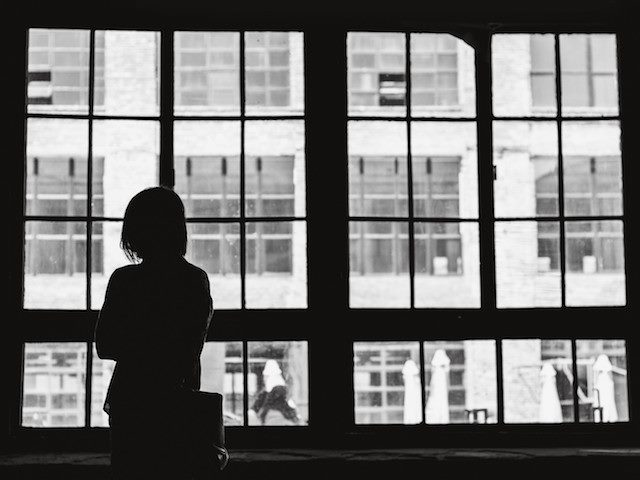 professional woman looking out an office window