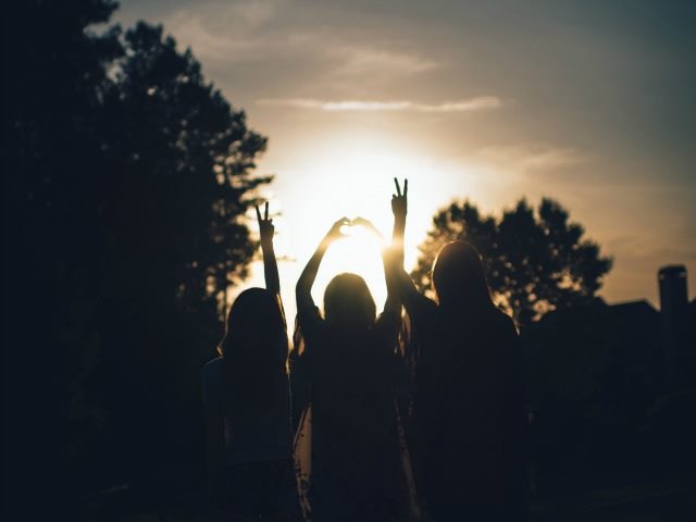 happy people looking at the sun