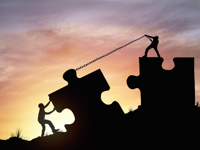 Silhouette people helping to connect jigsaw and puzzle to success - employee experience concept