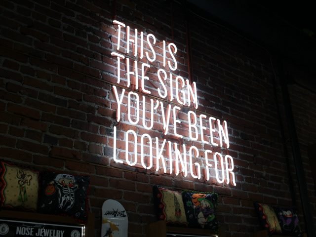 Neon sign: "This is the sign you've been looking for"