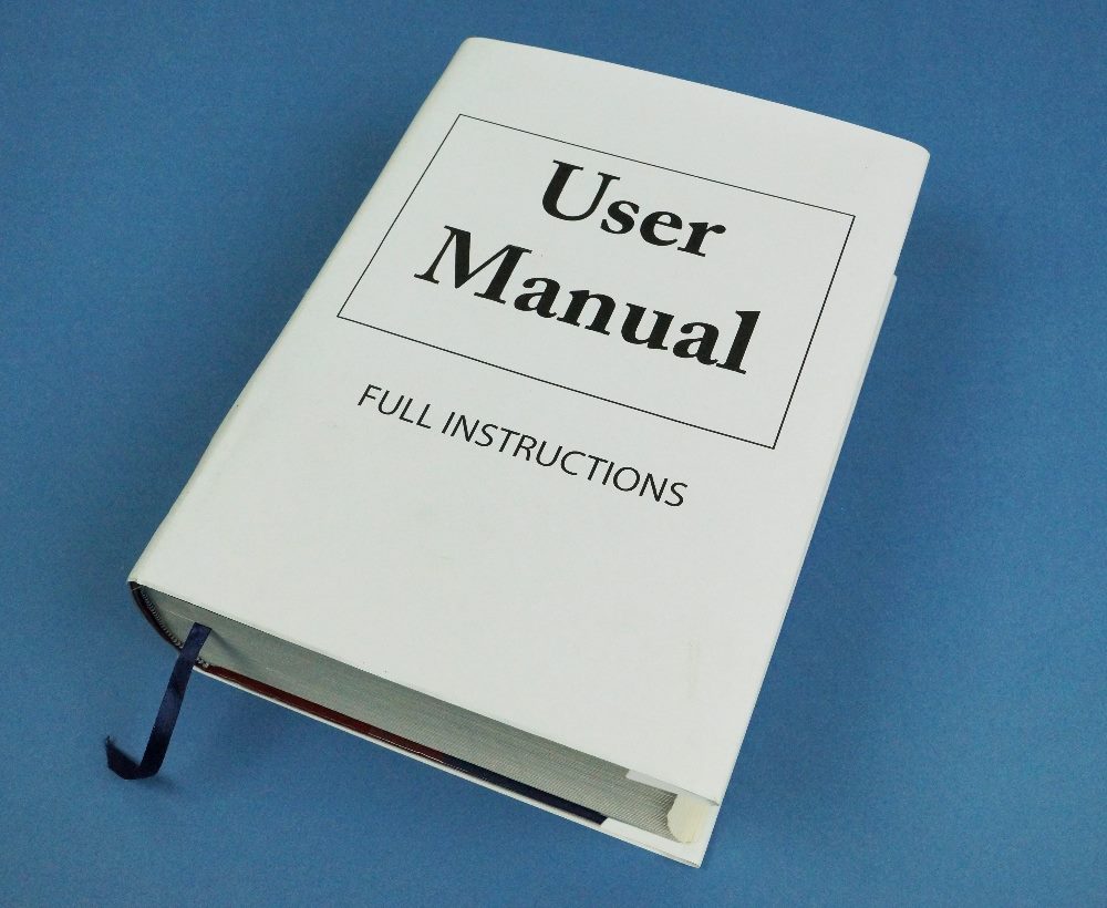 Large Book titled 'User Manual' suggesting that the task is very complicated in piece about user onboarding.