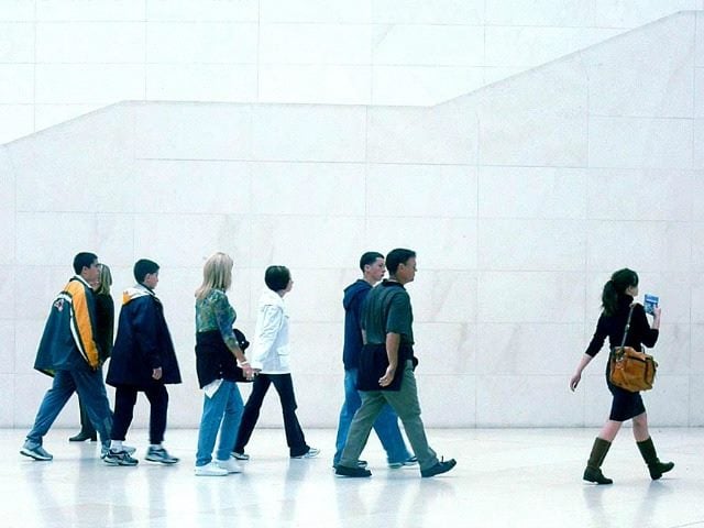 group of people following a woman