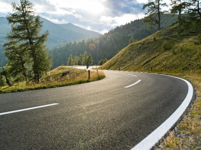 Asphalt, winding road in Austria on a summer day. 