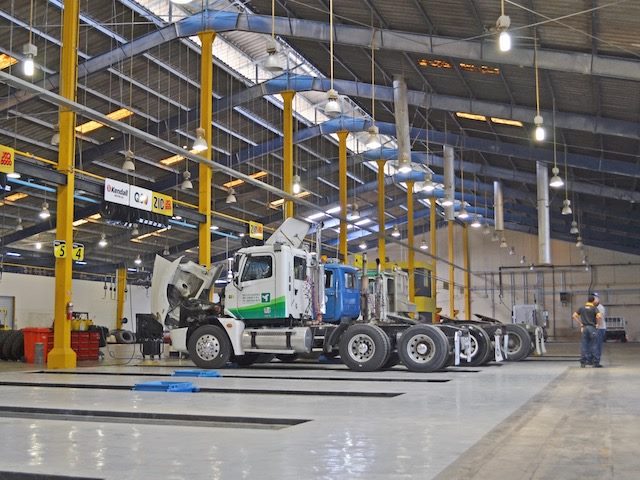 trucks lined up inside a garage
