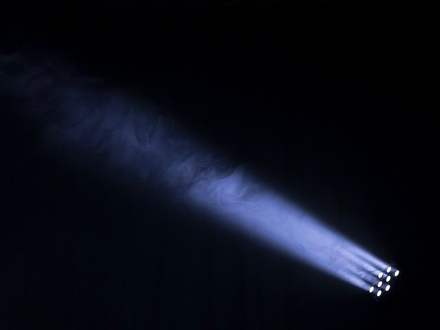search light beaming into a dark space
