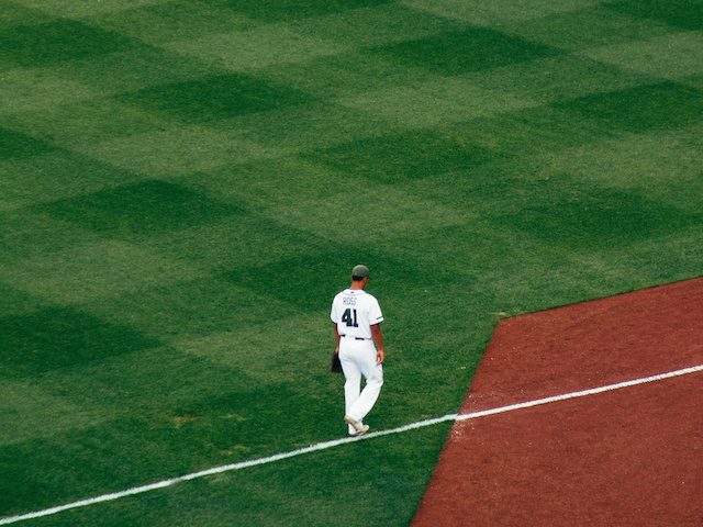 baseball player walking in the infield