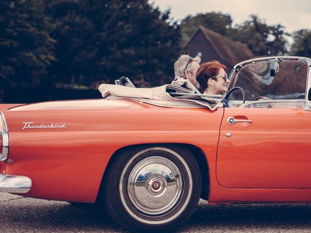 vintage convertible with two people inside